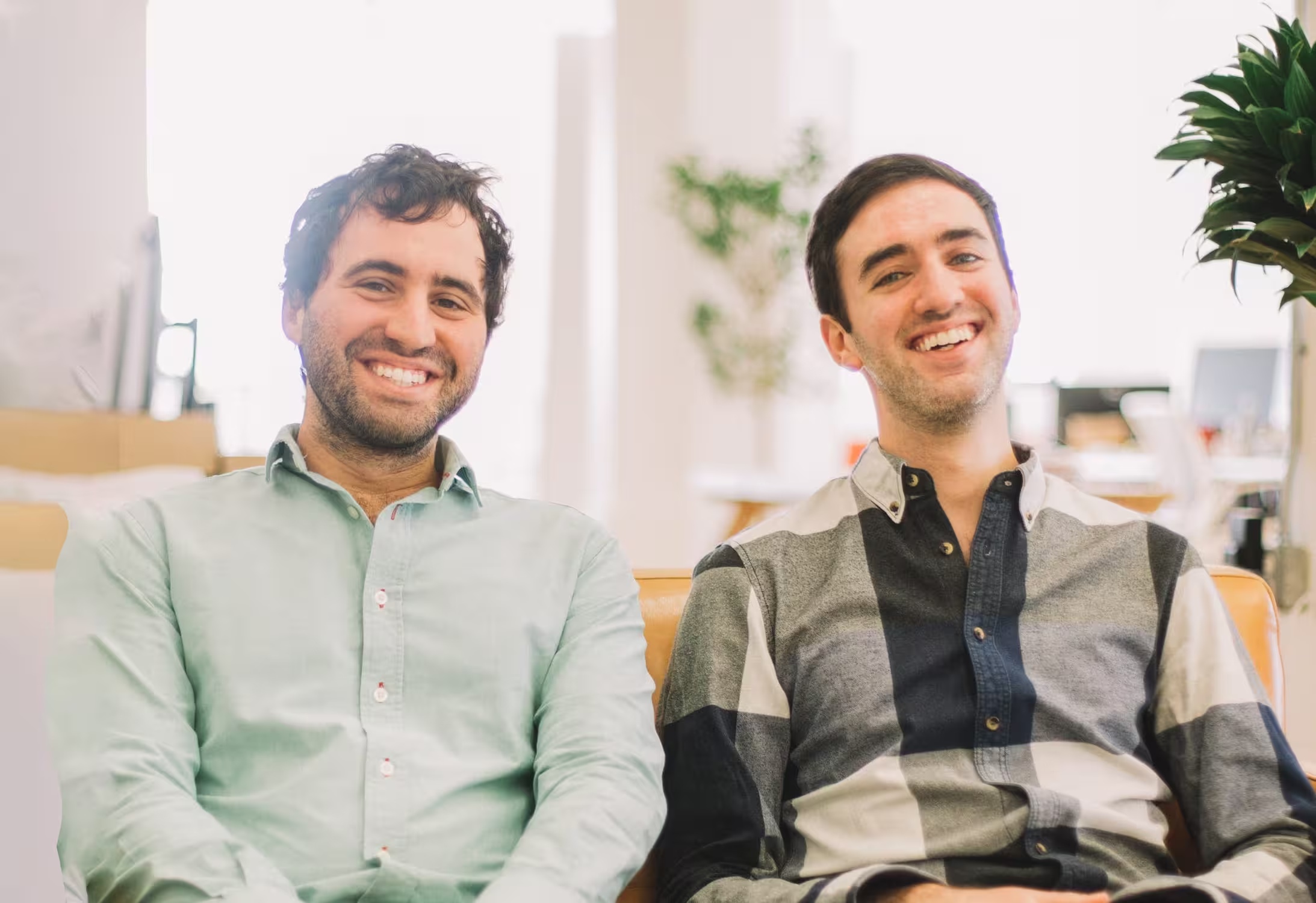 Demetri Karagas, left, and Steven Gutentag seated together on a sofa