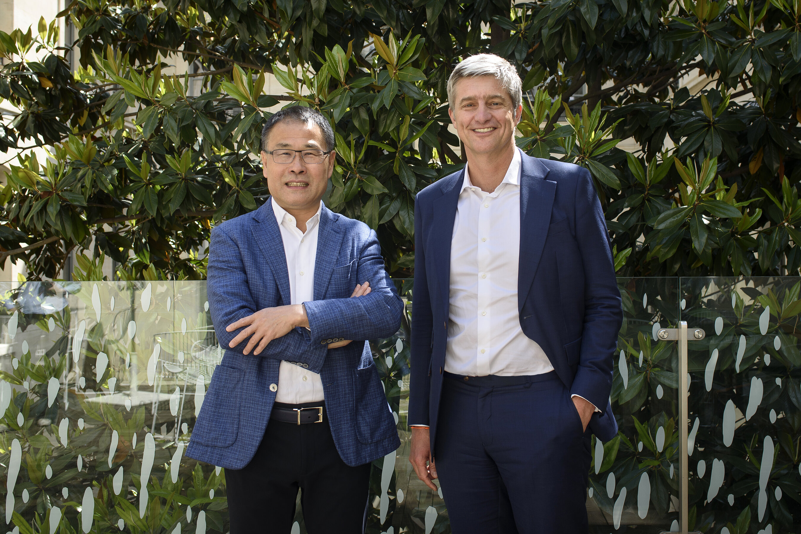 Cathay co-founders Mingpo Cai, left, and Denis Barrier, right, standing together outdoors