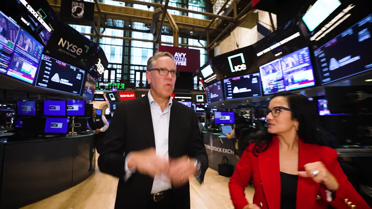 Deon Stander speaking with Judy Khan Shaw on the New York Stock Exchange floor