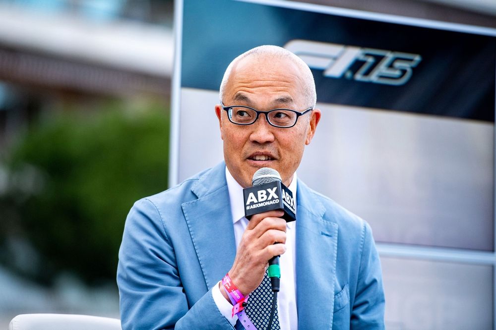 Derek Chang speaks into a microphone at the Autosport Business Exchange in Monaco