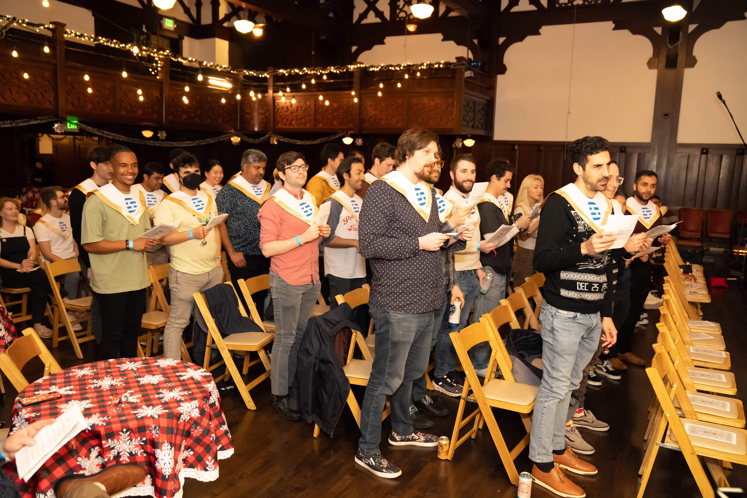 Descript team members holding printed sheets at a decorated gathering