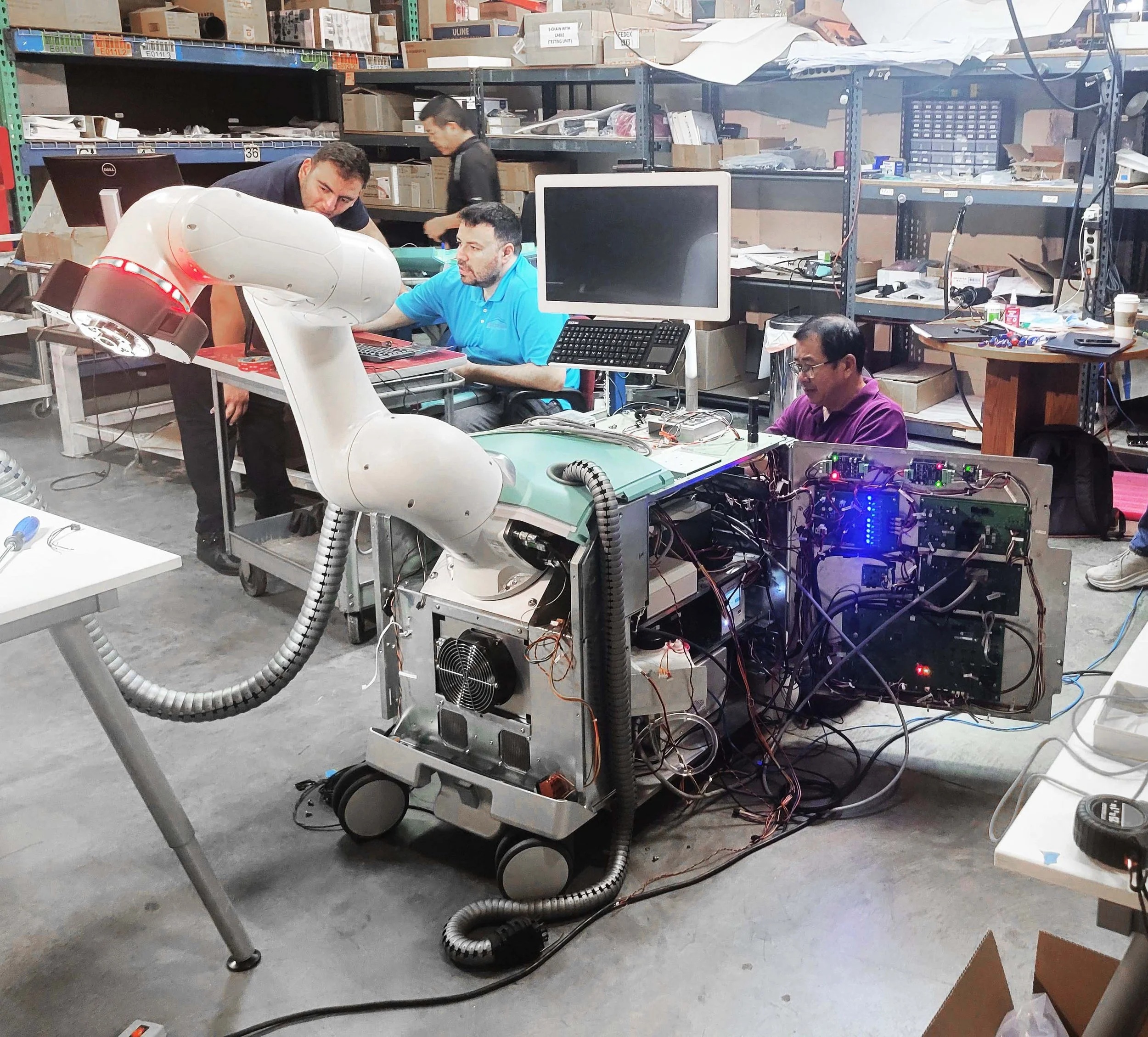 Design Catapult workshop team working around an open medical device with exposed electronics