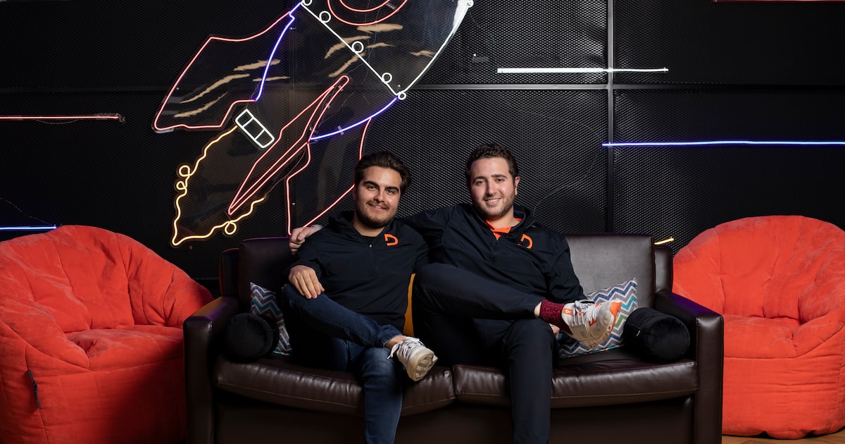 DEUNA co-founders seated together in a press photograph
