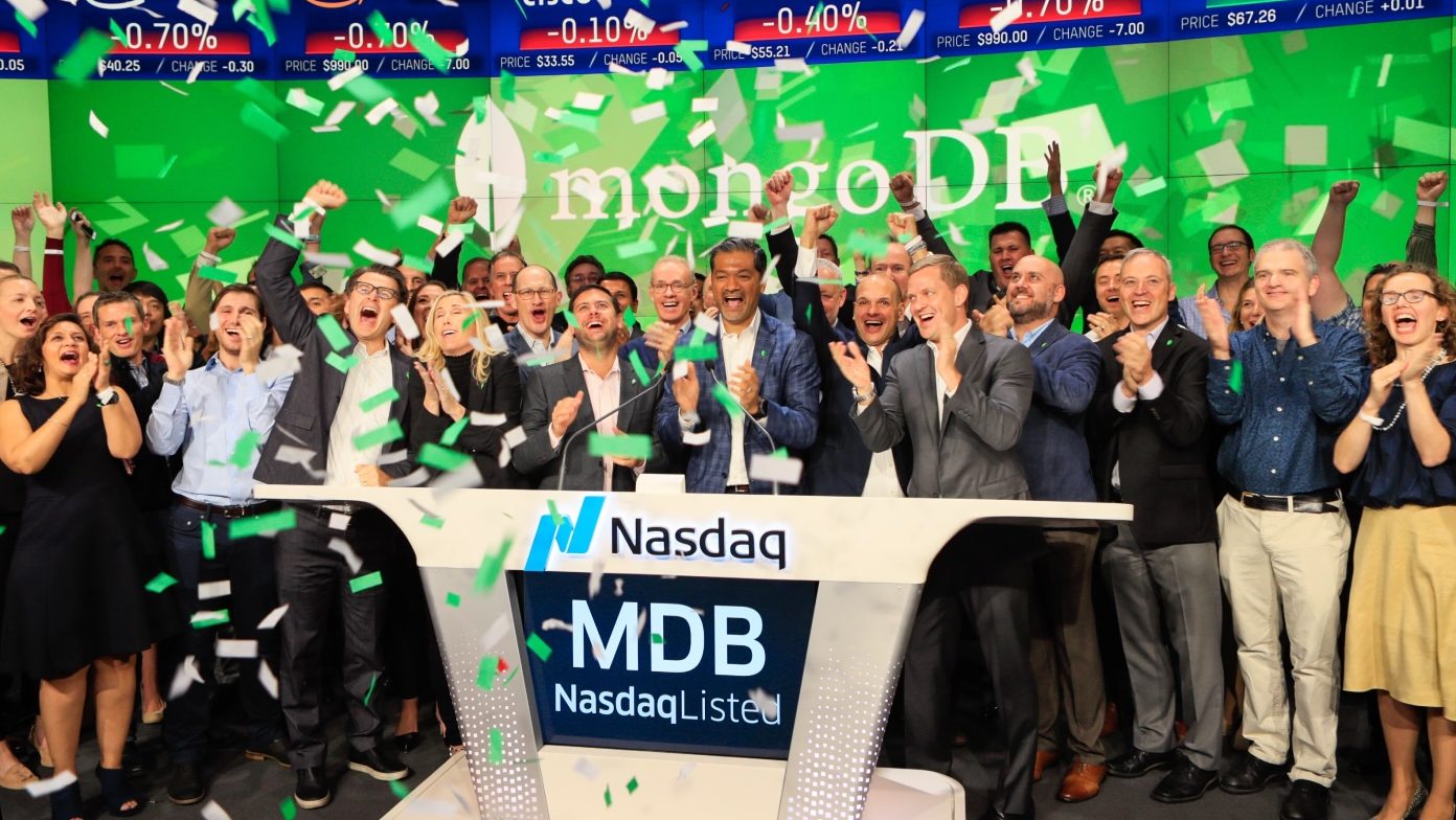 Dev Ittycheria and MongoDB colleagues celebrating the company's 2017 Nasdaq IPO amid green and white confetti