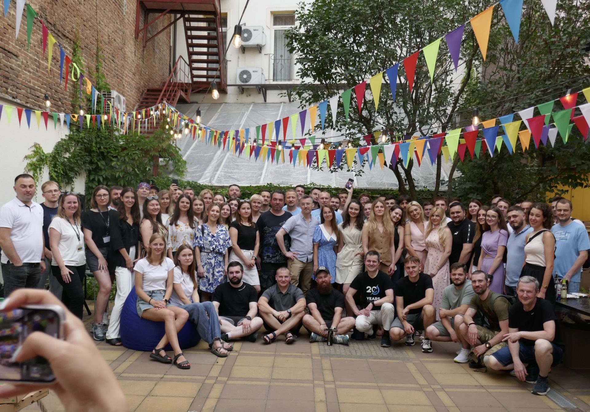 DevCom colleagues gathered in a courtyard beneath colorful bunting