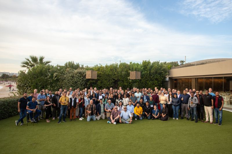 A large Sirion team gathered outdoors for a group photograph