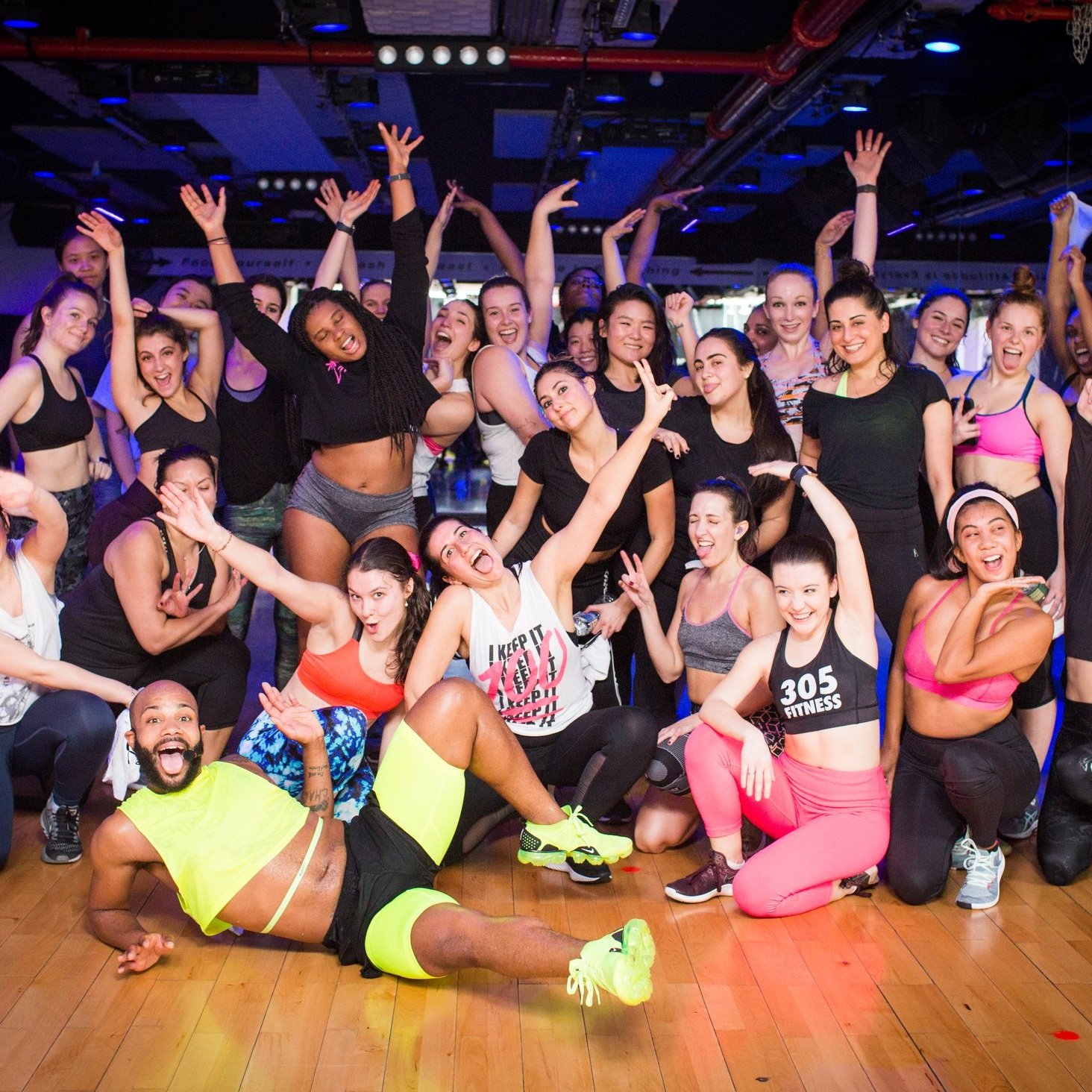A 305 Fitness dance-cardio class in a colorful studio