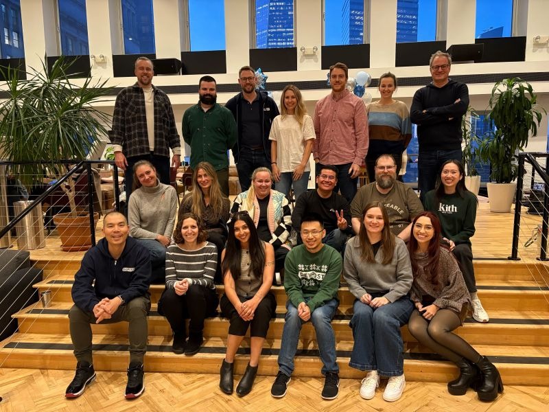 Devpost team gathered on stairs in its New York office