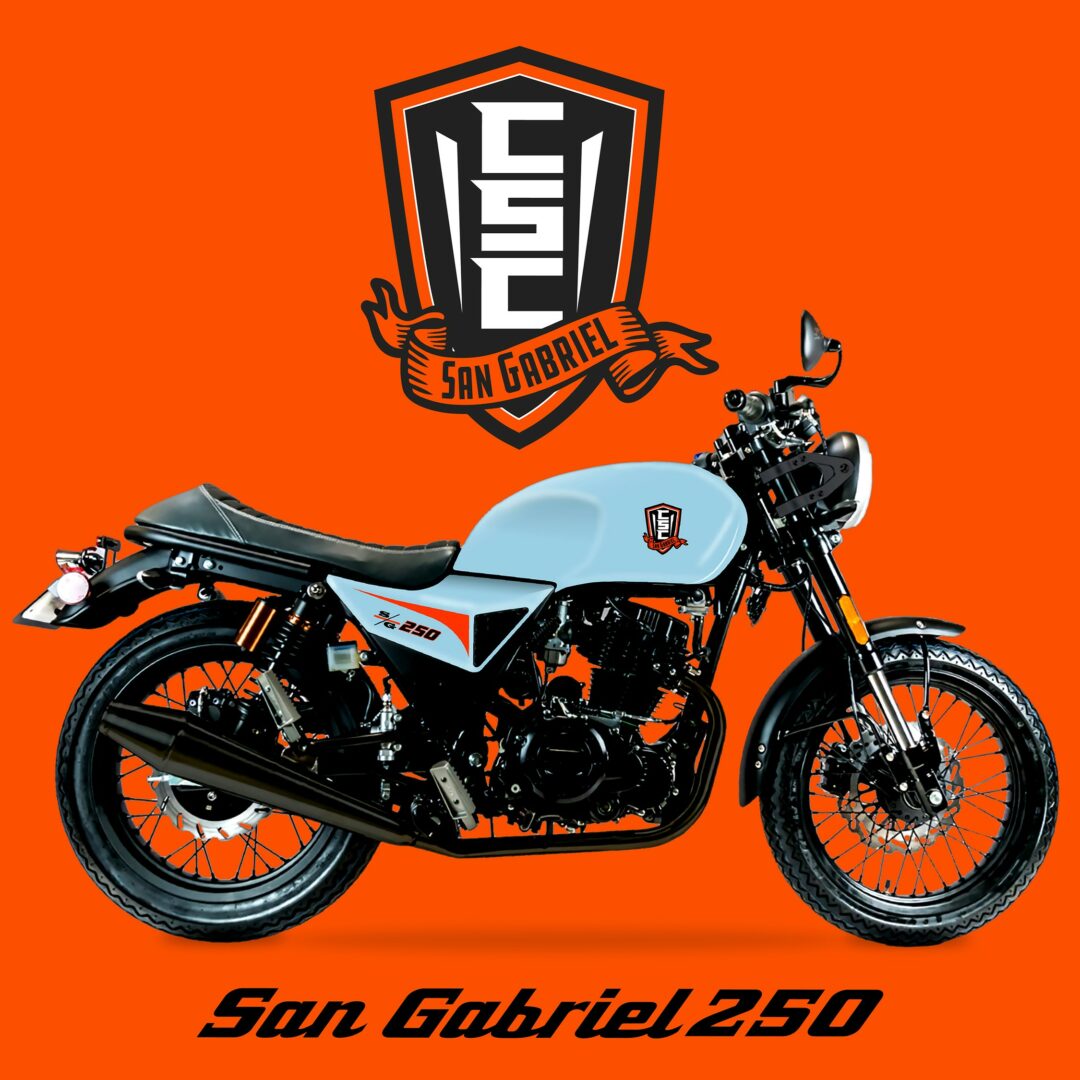 CSC San Gabriel 250 motorcycle with light blue tank, orange accents, and a large badge above it