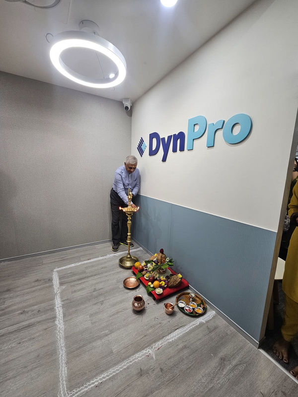 Dhruv Gupta beside the ceremonial lamp at DynPro’s Pune office inauguration