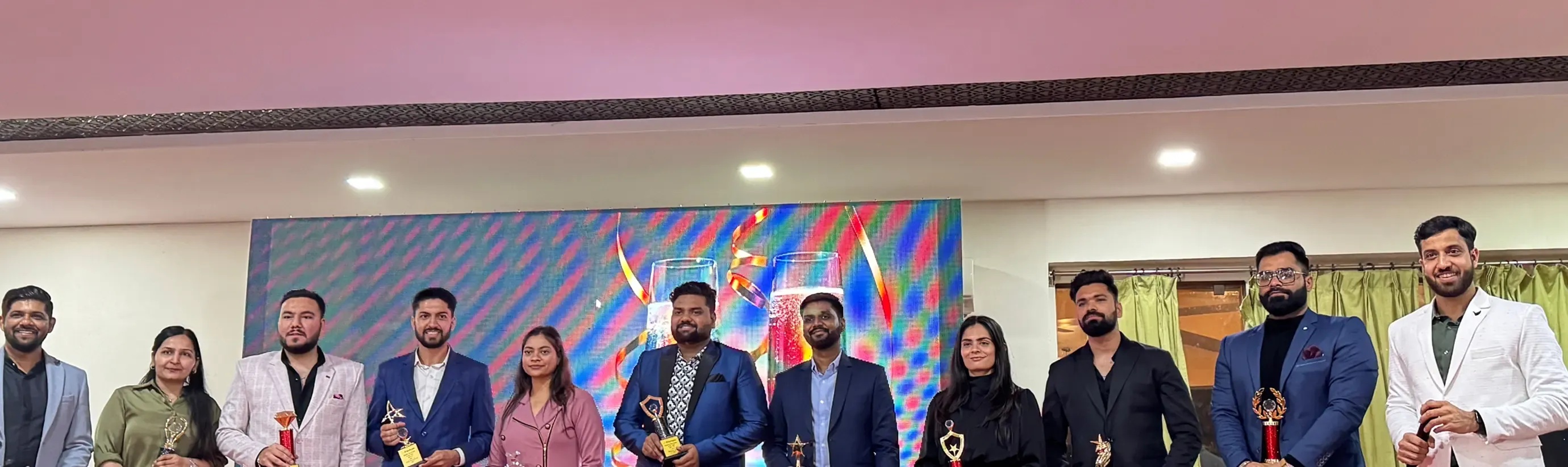 DianApps team members posing together with trophies at a company celebration