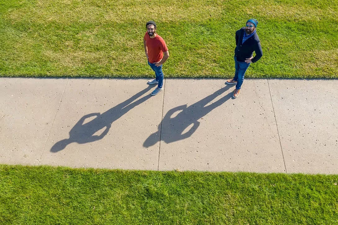 Daljeet Virdi and Dickey Singh looking up from a path on the Stanford grounds