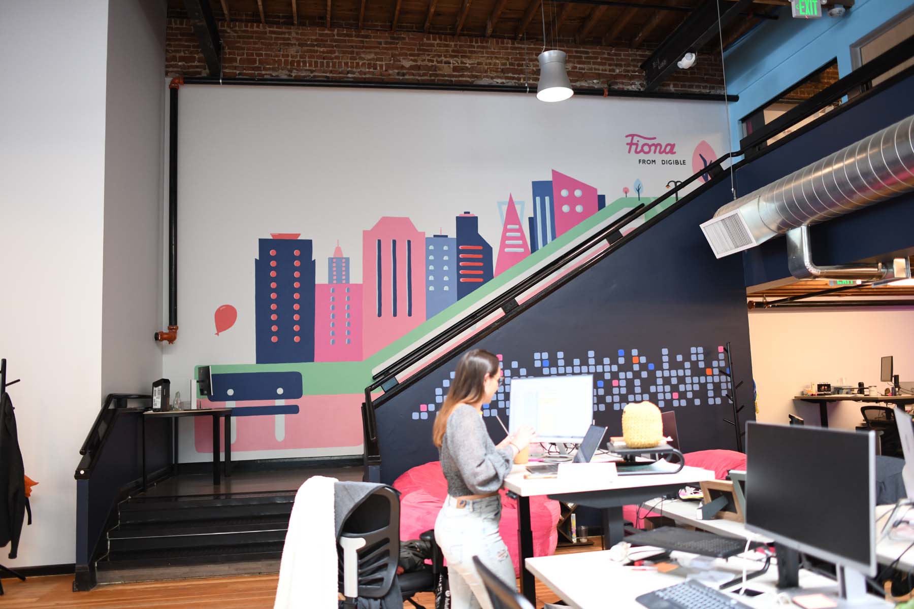 Digible's Englewood office with a colorful Fiona mural and workstations