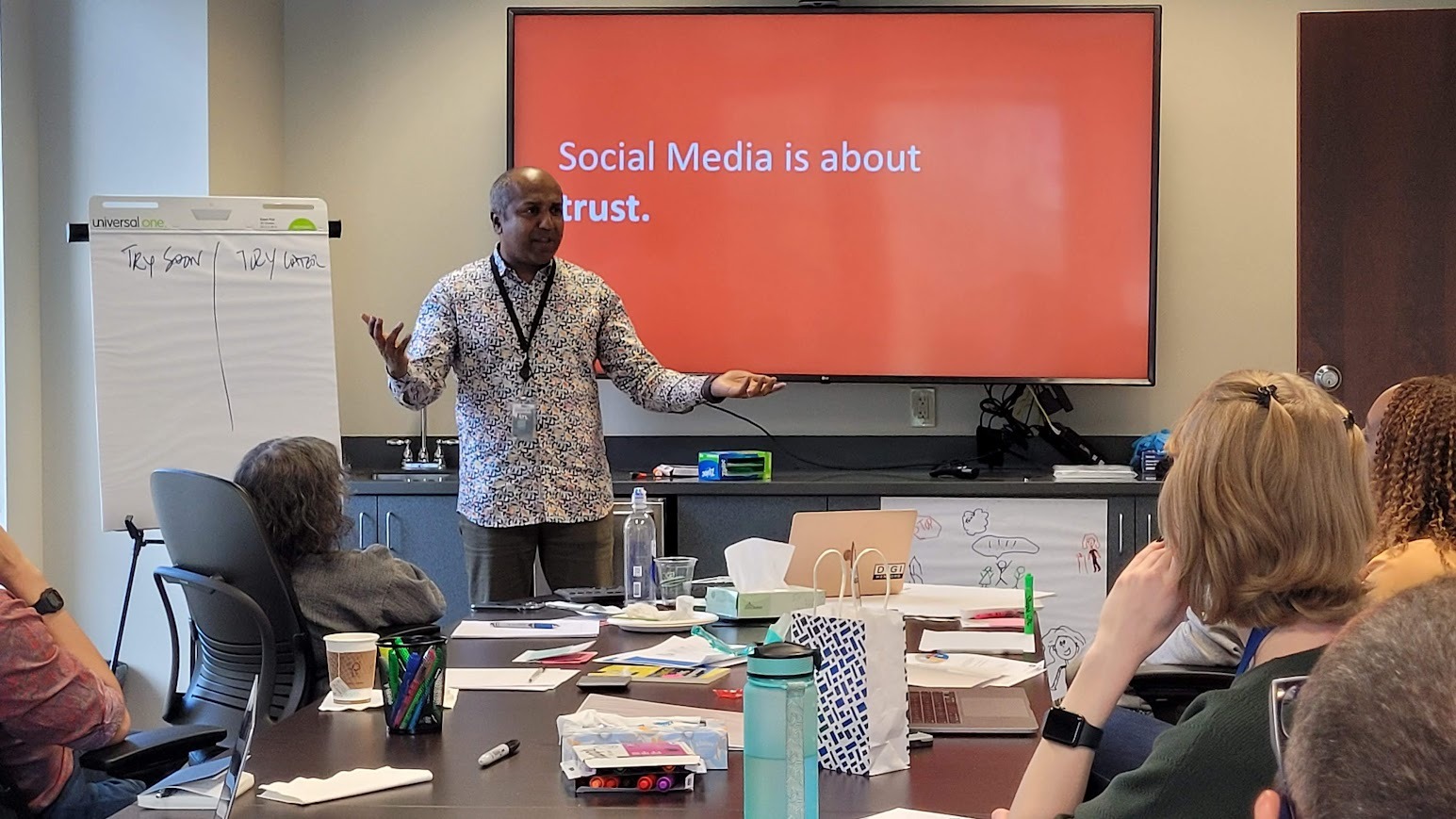 Sree Sreenivasan leads a workshop in front of a screen reading Social Media is about trust
