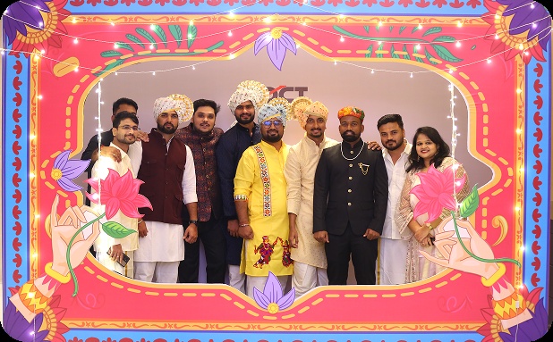 DCT colleagues posing together in a colorful celebration frame