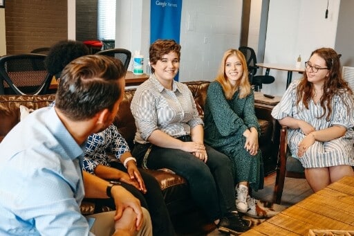 Digital Neighbor colleagues sit together in their Tampa office