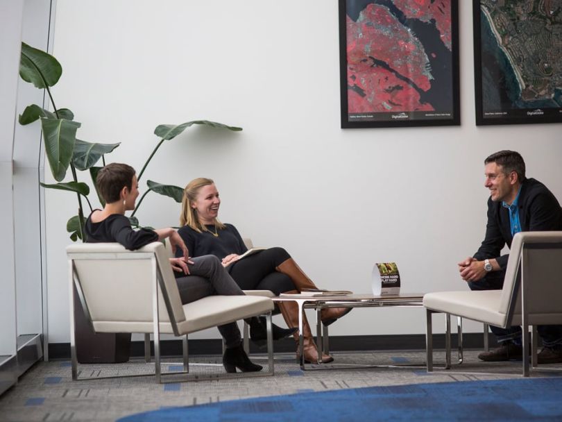 DigitalGlobe employees in conversation at the office