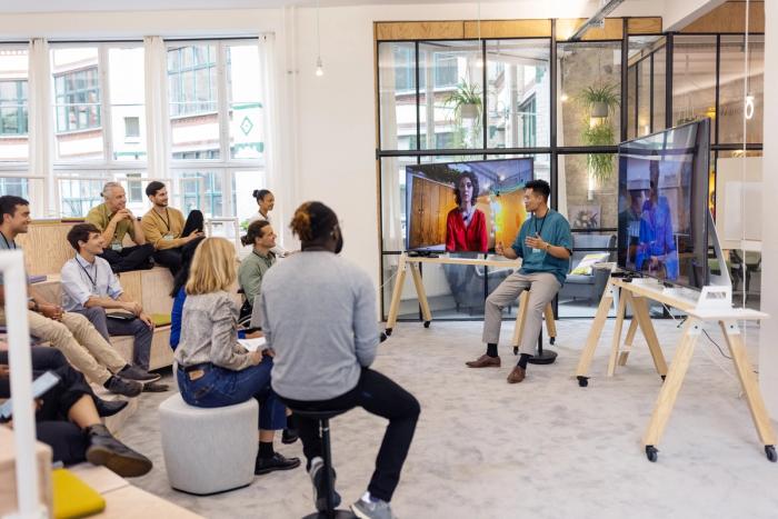 Diligent employees gathered for a presentation in a bright office