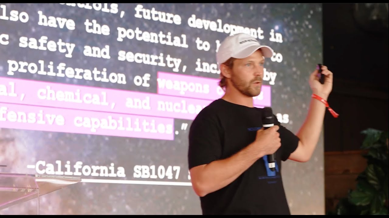 Dillon Rolnick speaking on stage at Nous Research