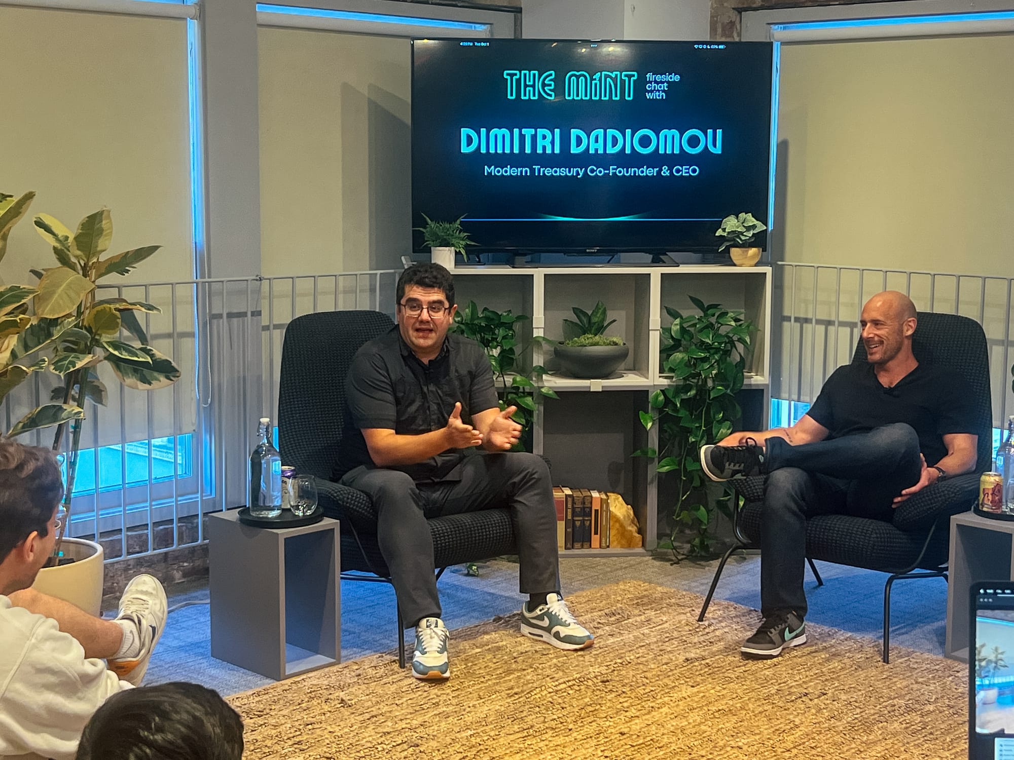 Dimitri Dadiomov, seated on the left, speaking at The Mint fireside chat