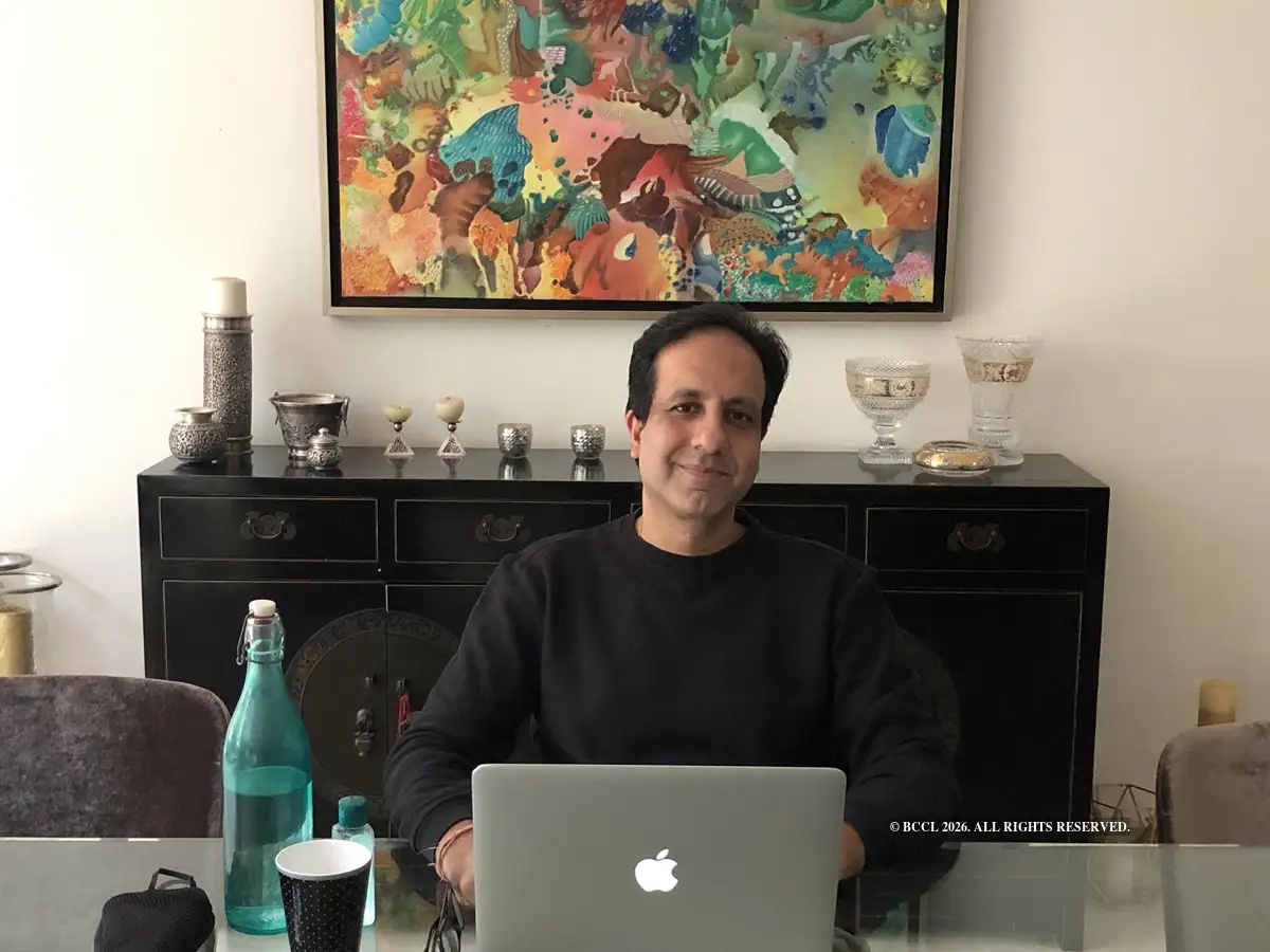 Dinesh Malkani working on a laptop at a table at home