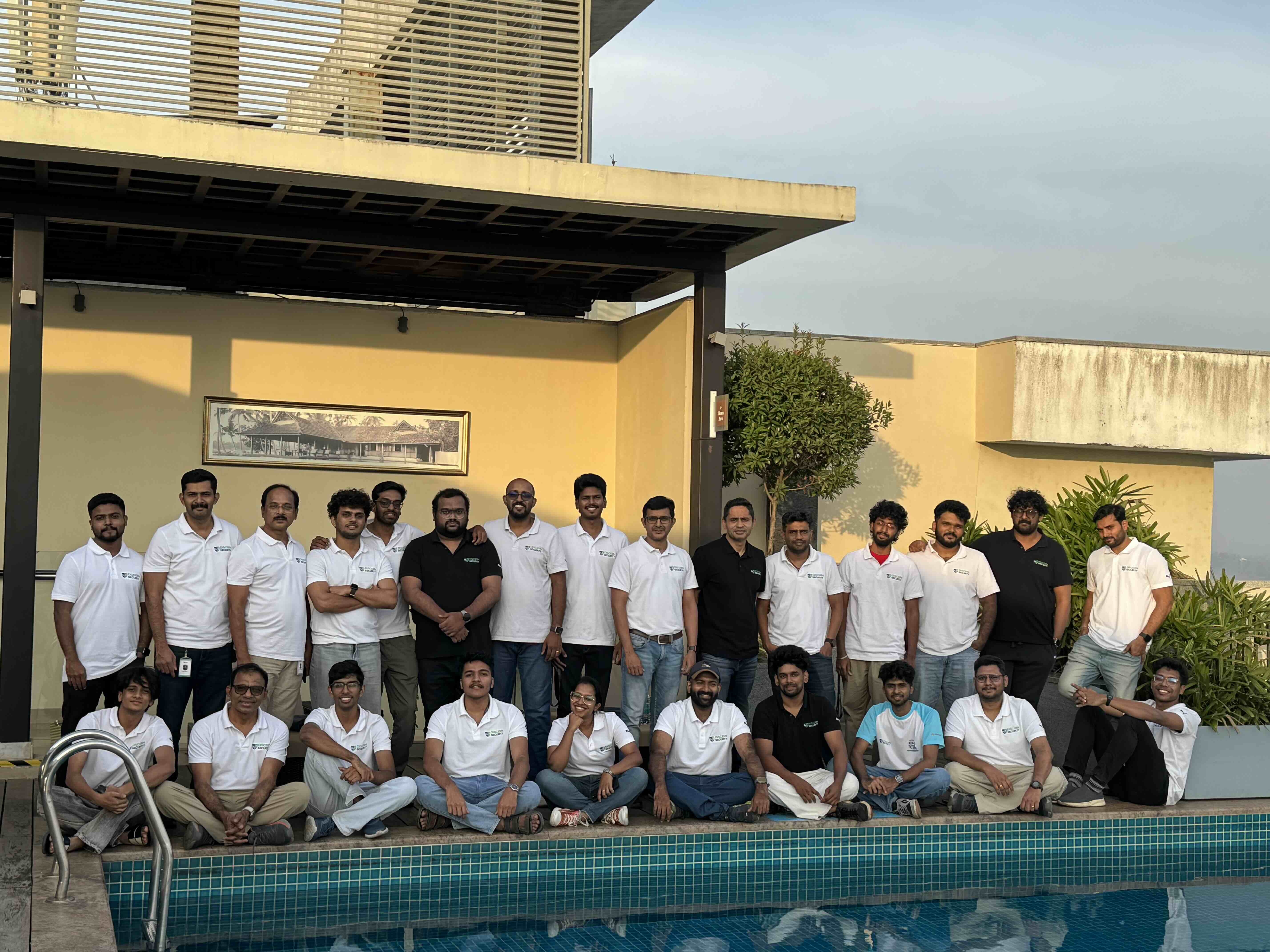 Discern Security team members posing beside a swimming pool