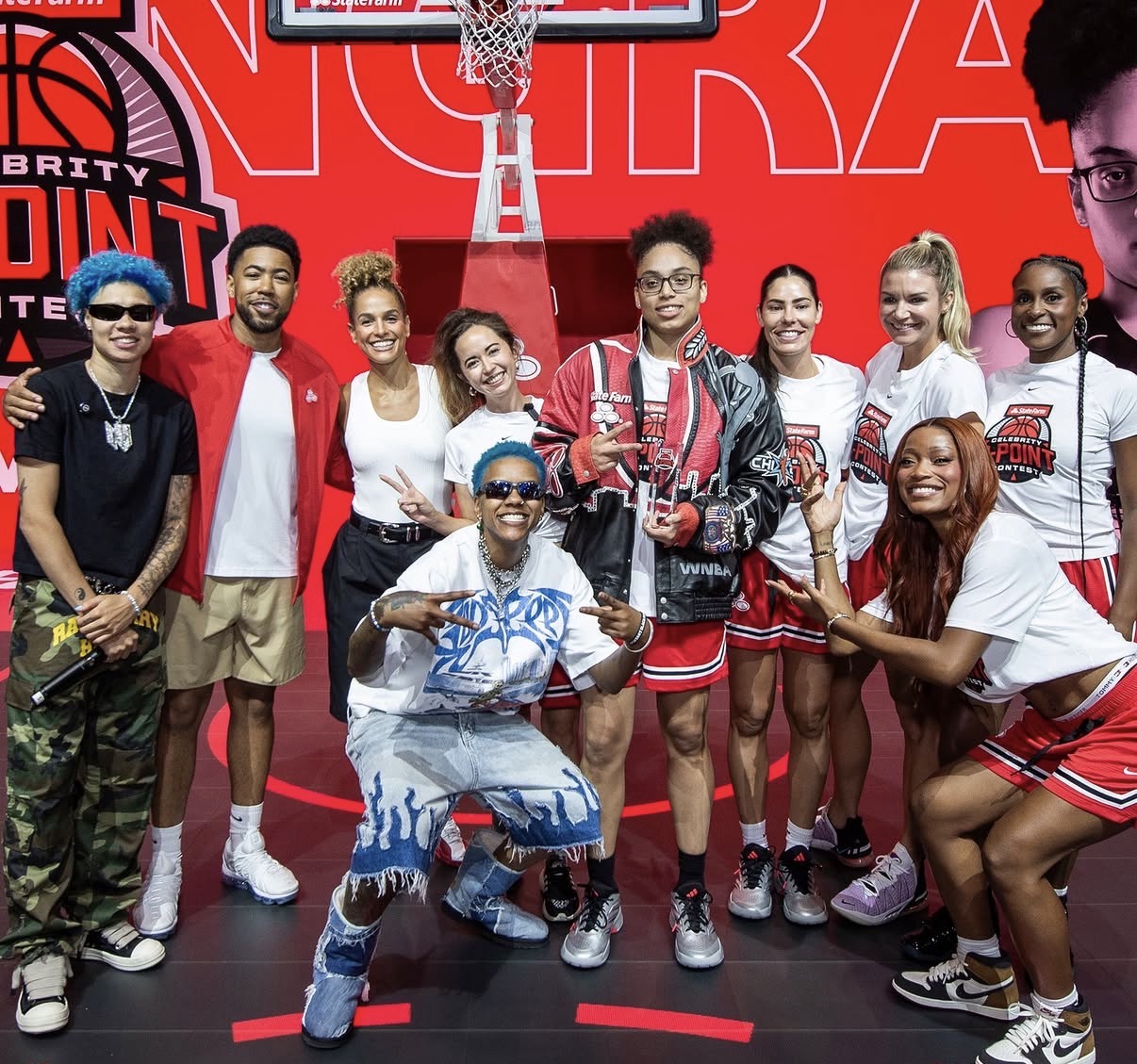 Participants at the State Farm Celebrity 3-Point Contest pose beneath a basketball hoop