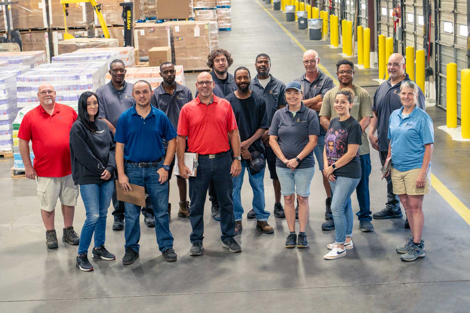 Distribution Technology team members standing together in a warehouse