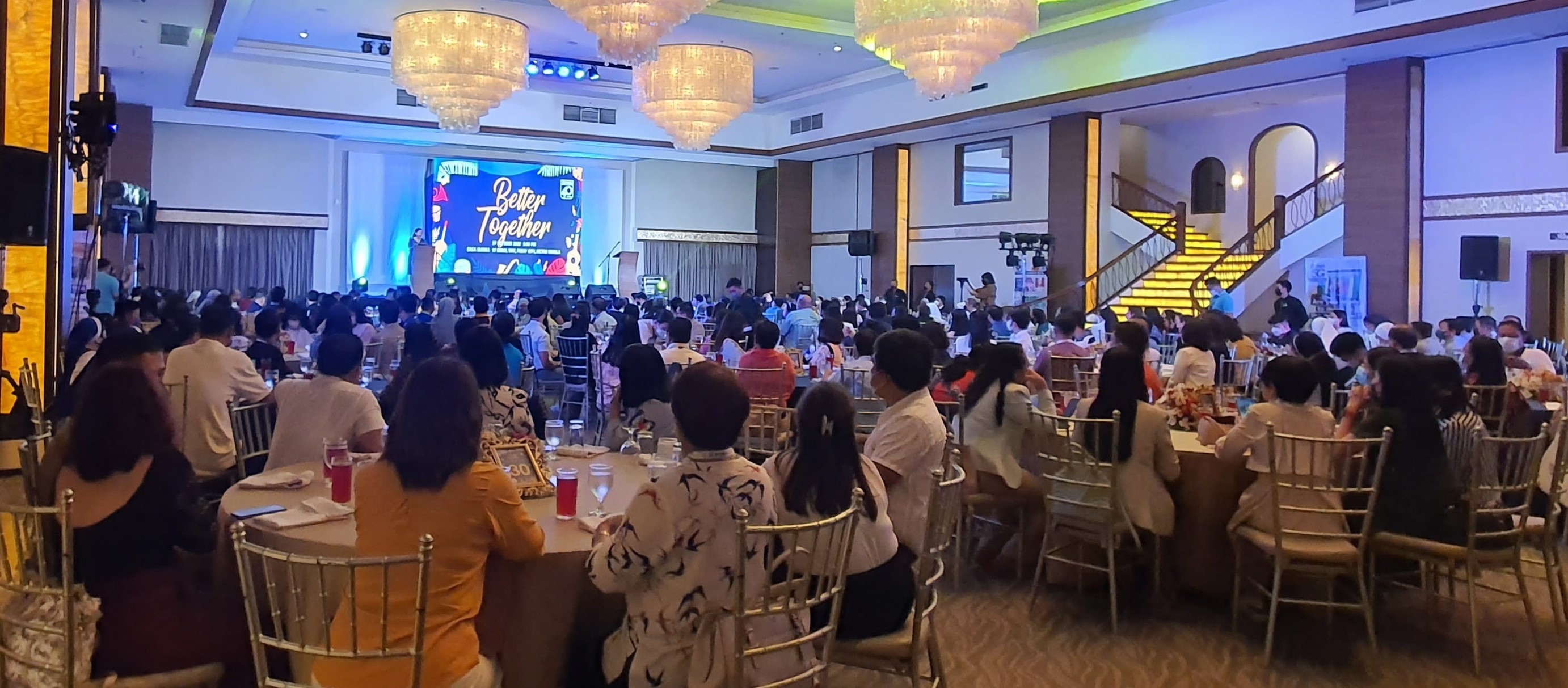 An audience seated at tables during a Diwa education gathering pictured in its fortieth-anniversary retrospective