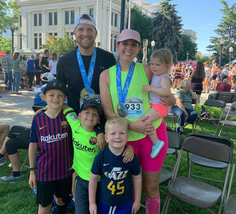DJ Dorff wearing a running medal, pictured outdoors with family