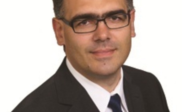 Archival photograph of Dmitry Rakovitsky in glasses, a dark suit and tie