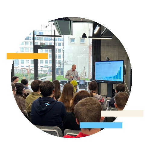 DNAnexus careers photograph showing a group listening to a presentation in an office