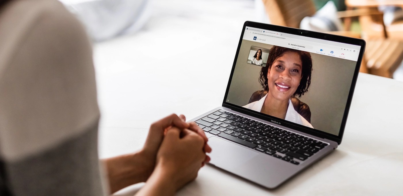 Patient speaks with a Doctor On Demand clinician on a laptop video visit