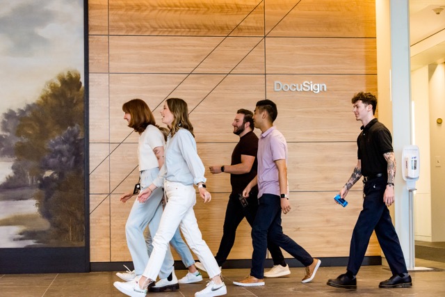 Employees walking together through a Docusign office lobby