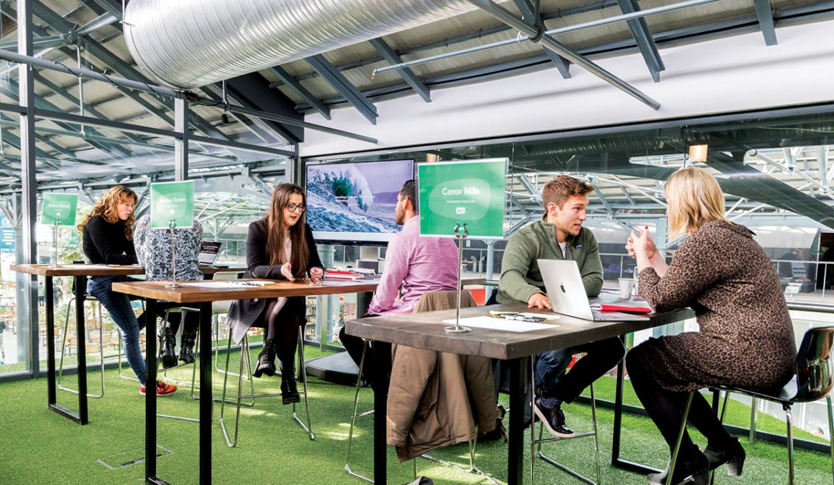 People in one-to-one conversations around tables in Dogpatch Labs’ Urban Garden