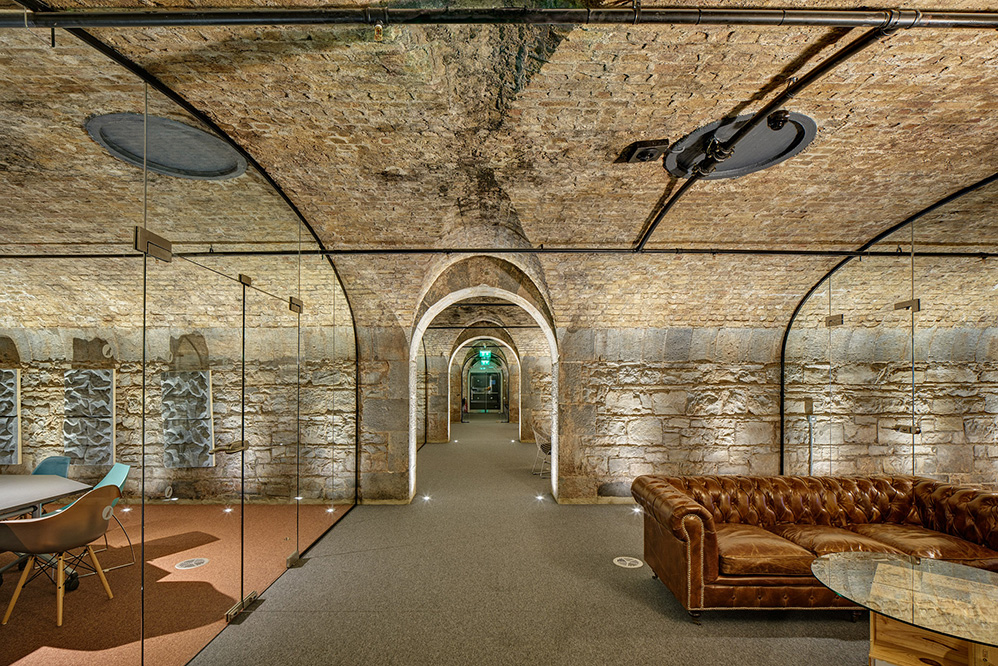 Brick vaulted ceilings above glass meeting rooms and leather seating at Dogpatch Labs