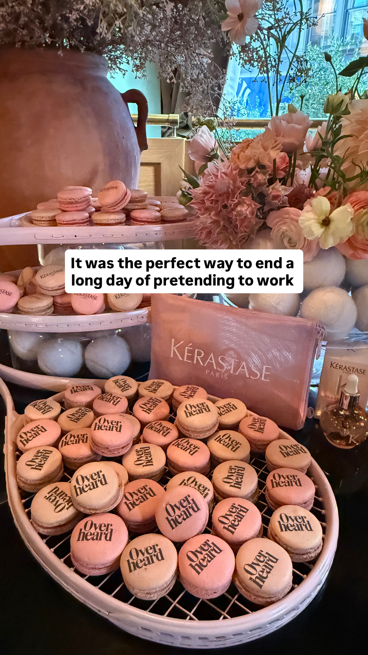 Overheard and Kérastase branded macarons displayed among flowers at a campaign event