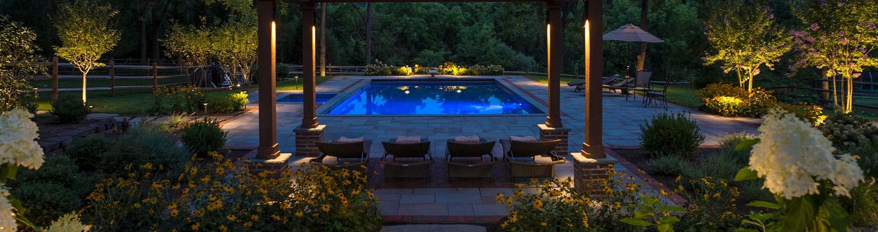 Landscape lighting across a residential exterior at night