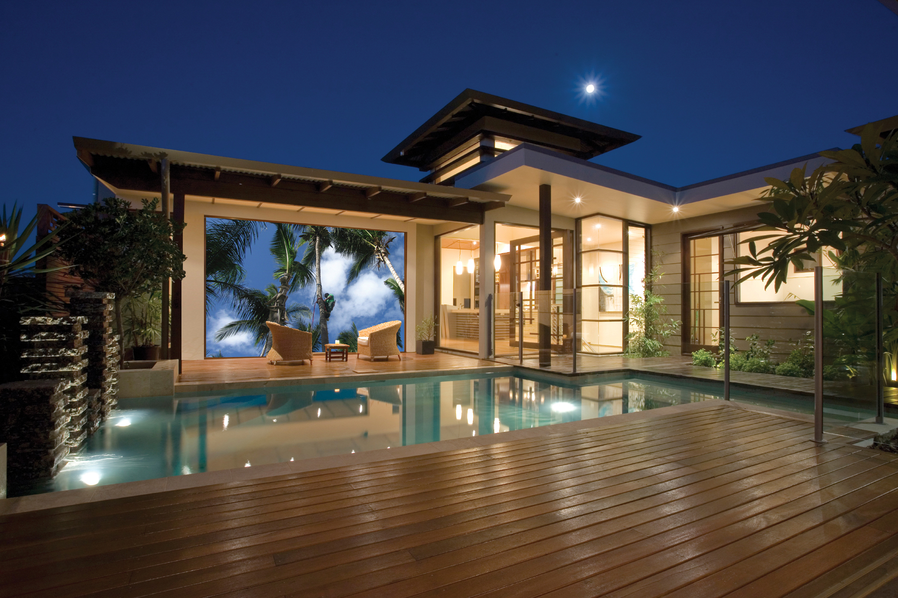 Poolside outdoor audio and living space at dusk