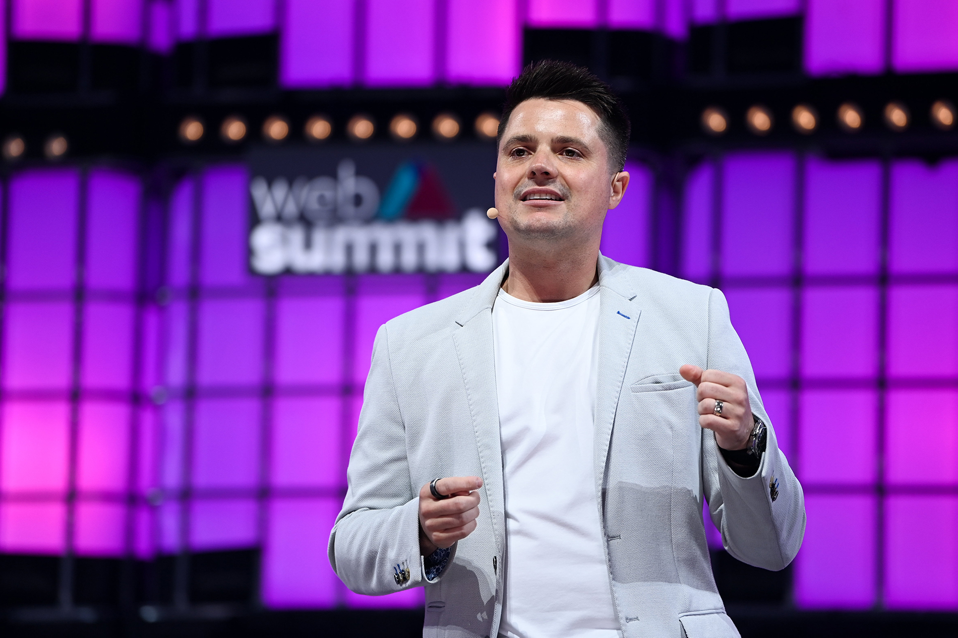 Domm Holland speaking on stage at Web Summit 2021 in Lisbon