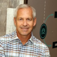 Don Armstrong in a checked shirt, photographed in an office setting