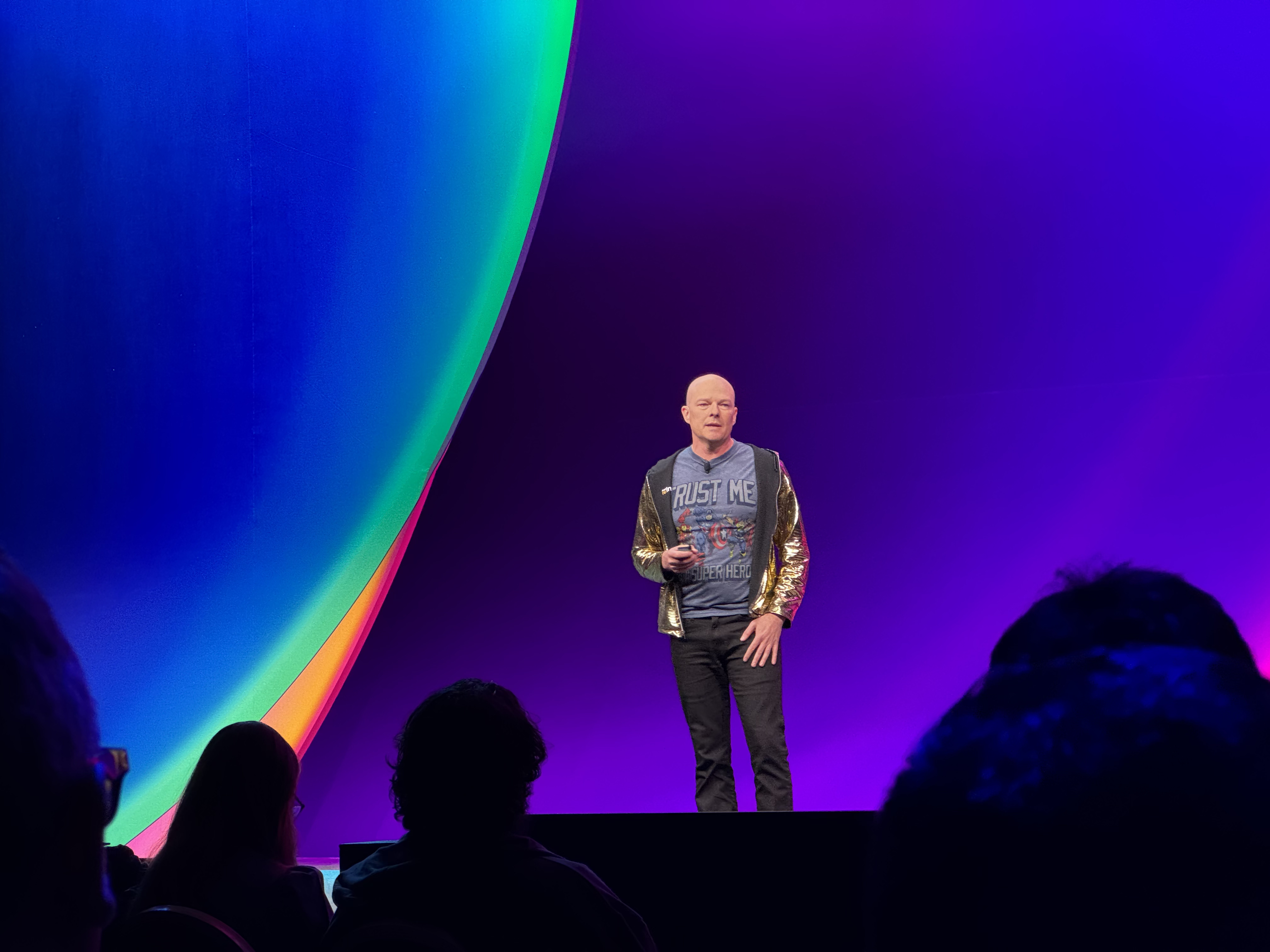 Don MacAskill speaking on a brightly lit stage at AWS re:Invent 2024