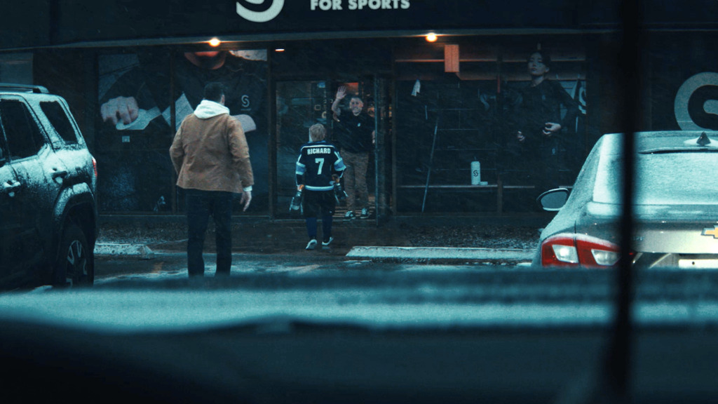 A father and son enter a Source for Sports store in the Hometowns Like These campaign
