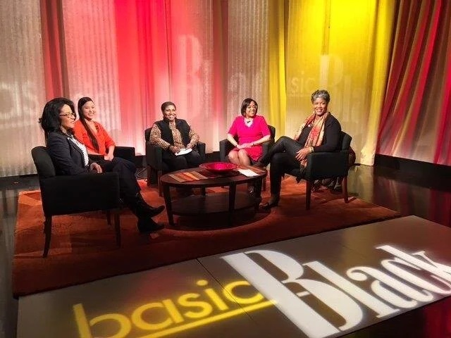 A five-person panel seated on the Basic Black television set, pictured on Donna Latson Gittens’s speaking website
