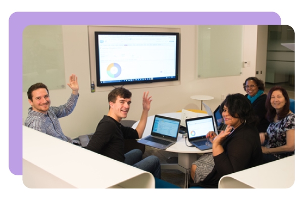 DonorPerfect team members collaborating around a table