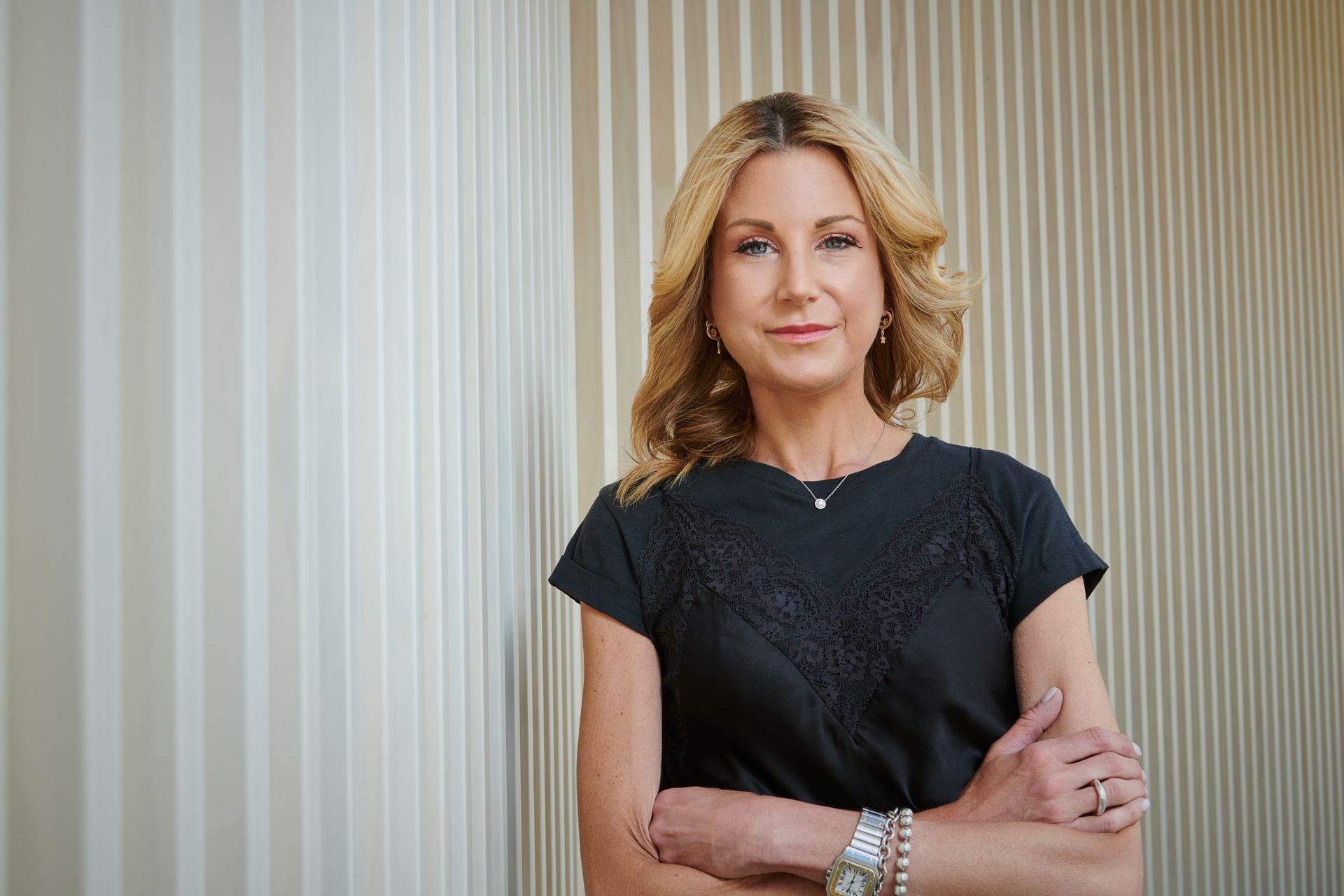 Dopamine Studios founder Melanie Kentish standing against a ribbed wall
