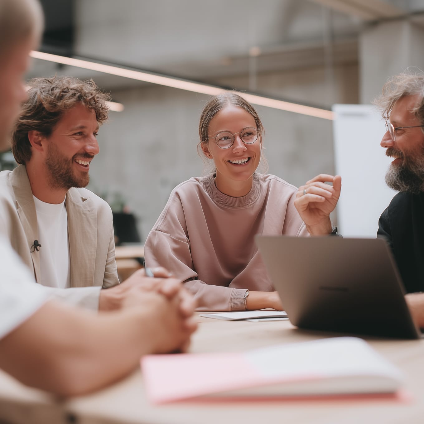 People gathered around a laptop in Dotdigital's promotional website imagery