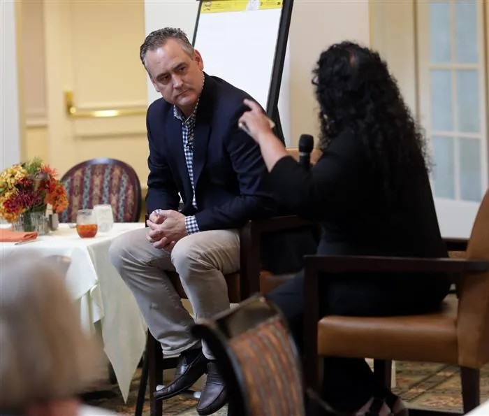 Doug Lebda listens to Saras Sarasvathy during a seated conversation at Darden