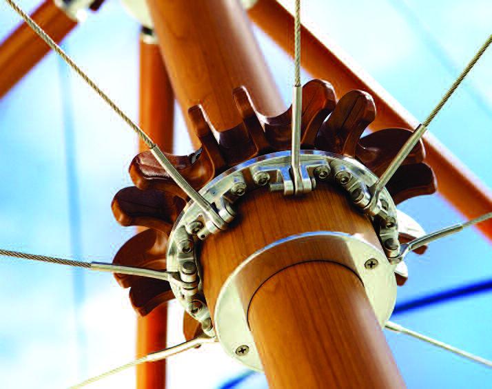 Close view of a Tuuci parasol hub with metal fittings, lines and wooden struts