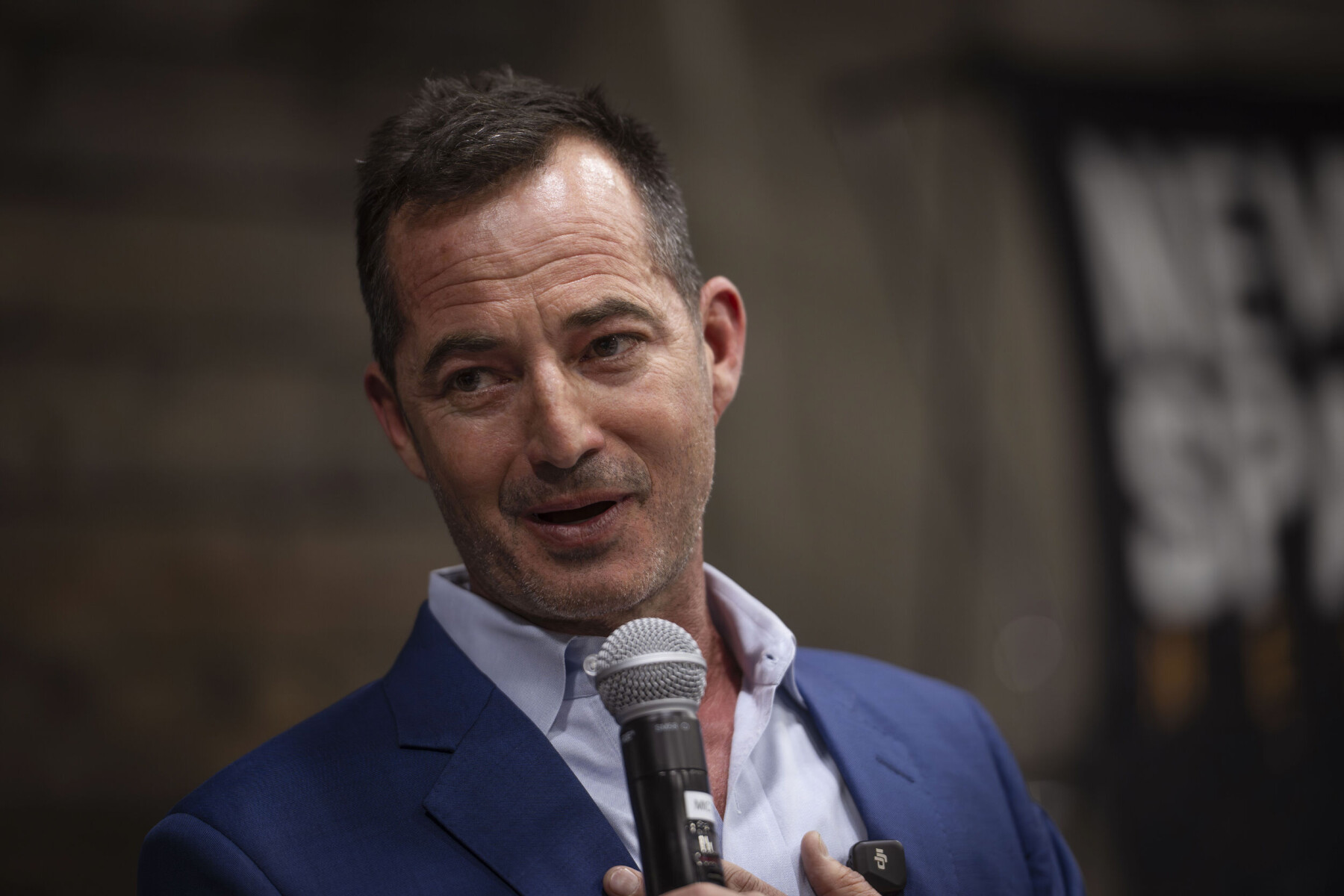 Douglas Turner holding a microphone at a NewSpace Nexus candidate event